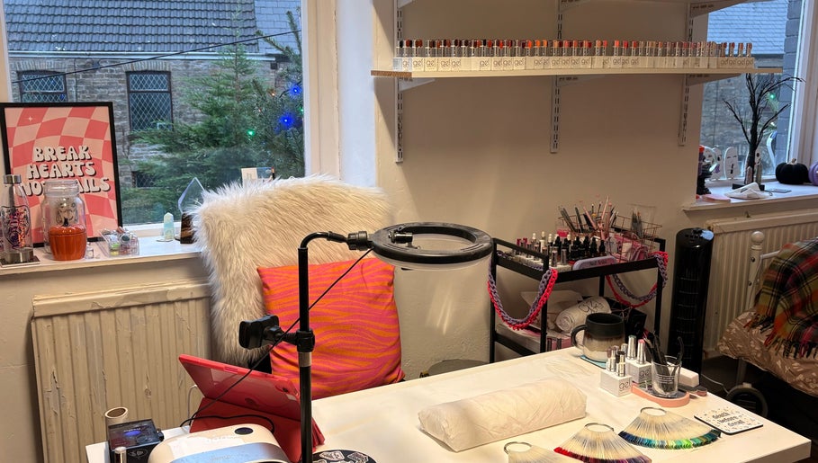 Cozy nail art station at Haus of Pixiee, Pontyclun, Wales, GB, featuring vibrant gel polish display.