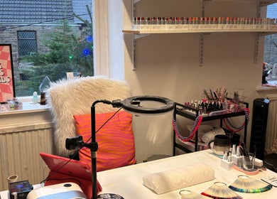 Cozy nail art station at Haus of Pixiee, Pontyclun, Wales, GB, featuring vibrant gel polish display.