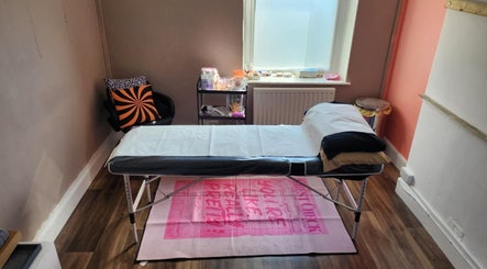 Cozy treatment room at Haus of Pixiee, Pontyclun, Wales, GB, featuring a comfortable massage table.