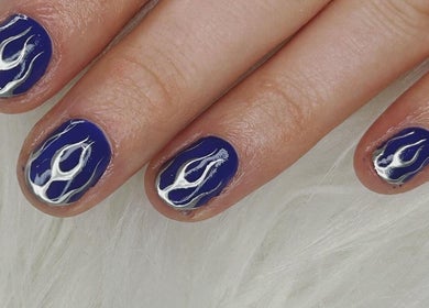 Close-up of blue flame nail art at Haus of Pixiee, Pontyclun, Wales, GB.