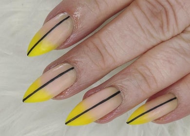 Stylish yellow-tipped nails with black lines at Haus of Pixiee, Pontyclun, Wales, GB.