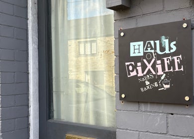 Haus of Pixiee exterior sign on grey brick wall in Pontyclun, Wales, GB.