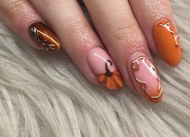 Stylish autumn-themed nail art at Haus of Pixiee in Pontyclun, Wales, GB showcasing warm hues and intricate designs.