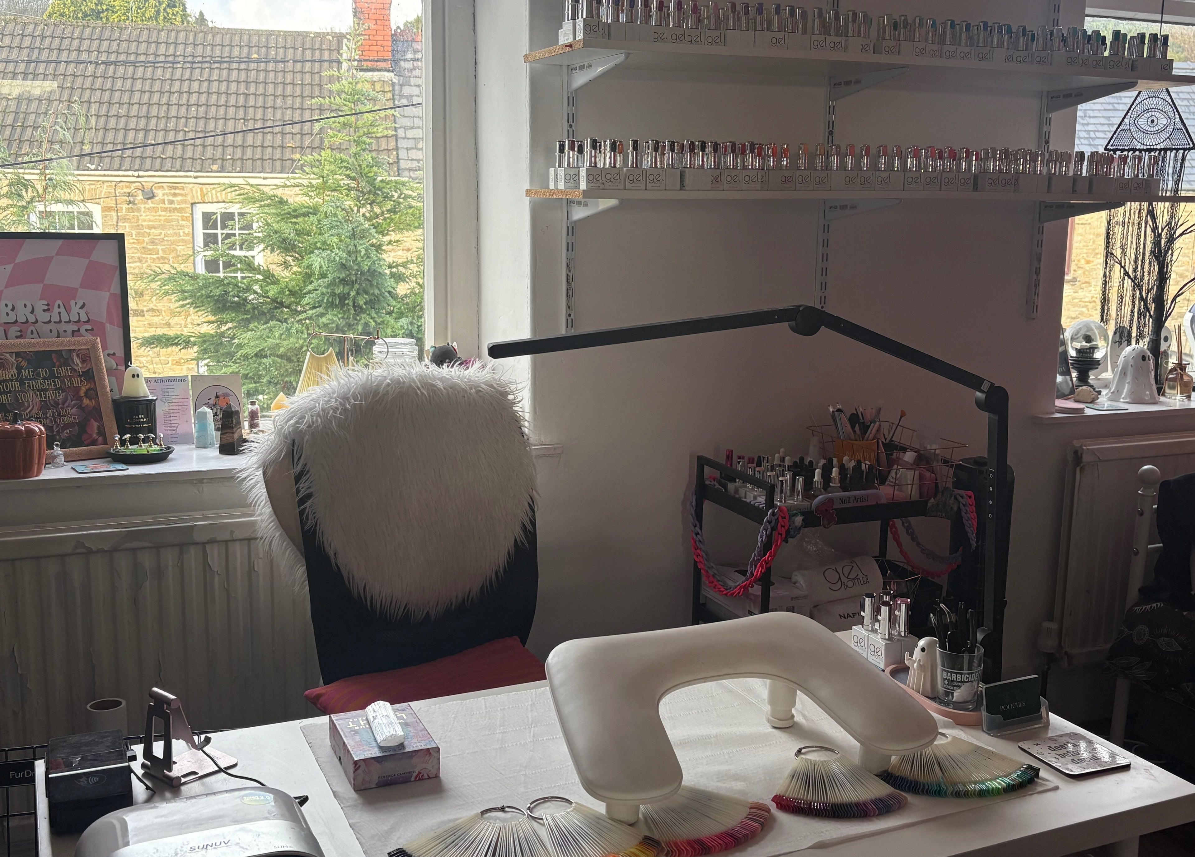 Cozy nail station at Haus of Pixiee, Pontyclun, Wales, GB, featuring elegant decor and nail polish display.