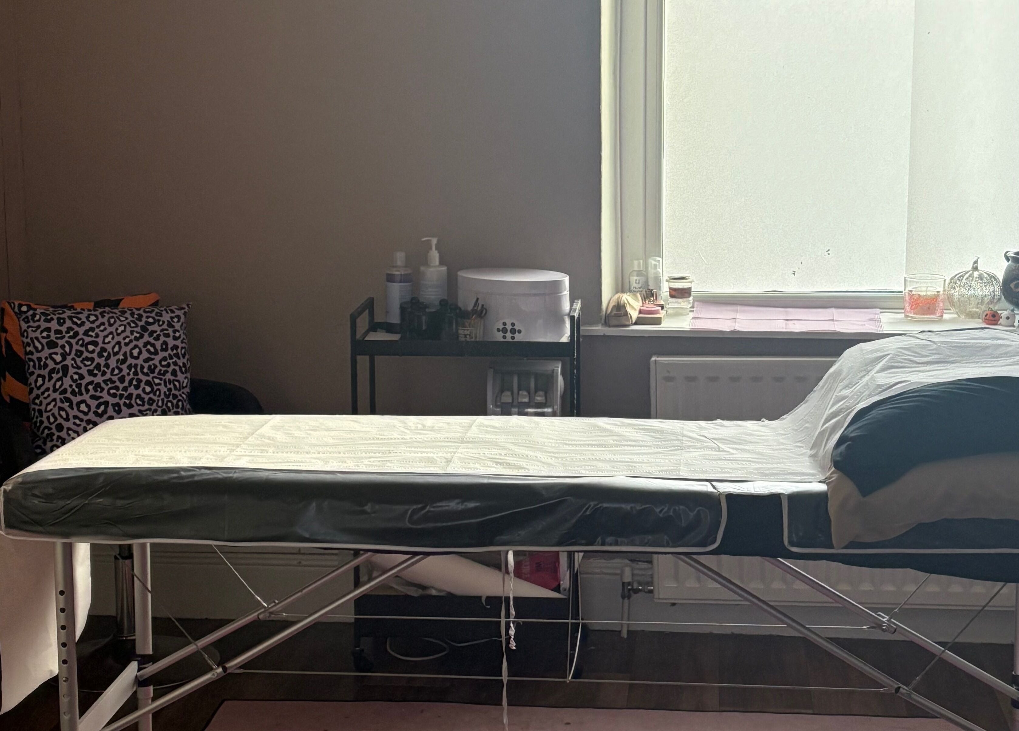 Relaxing spa treatment room at Haus of Pixiee, Pontyclun, Wales, GB, featuring a comfortable massage bed.