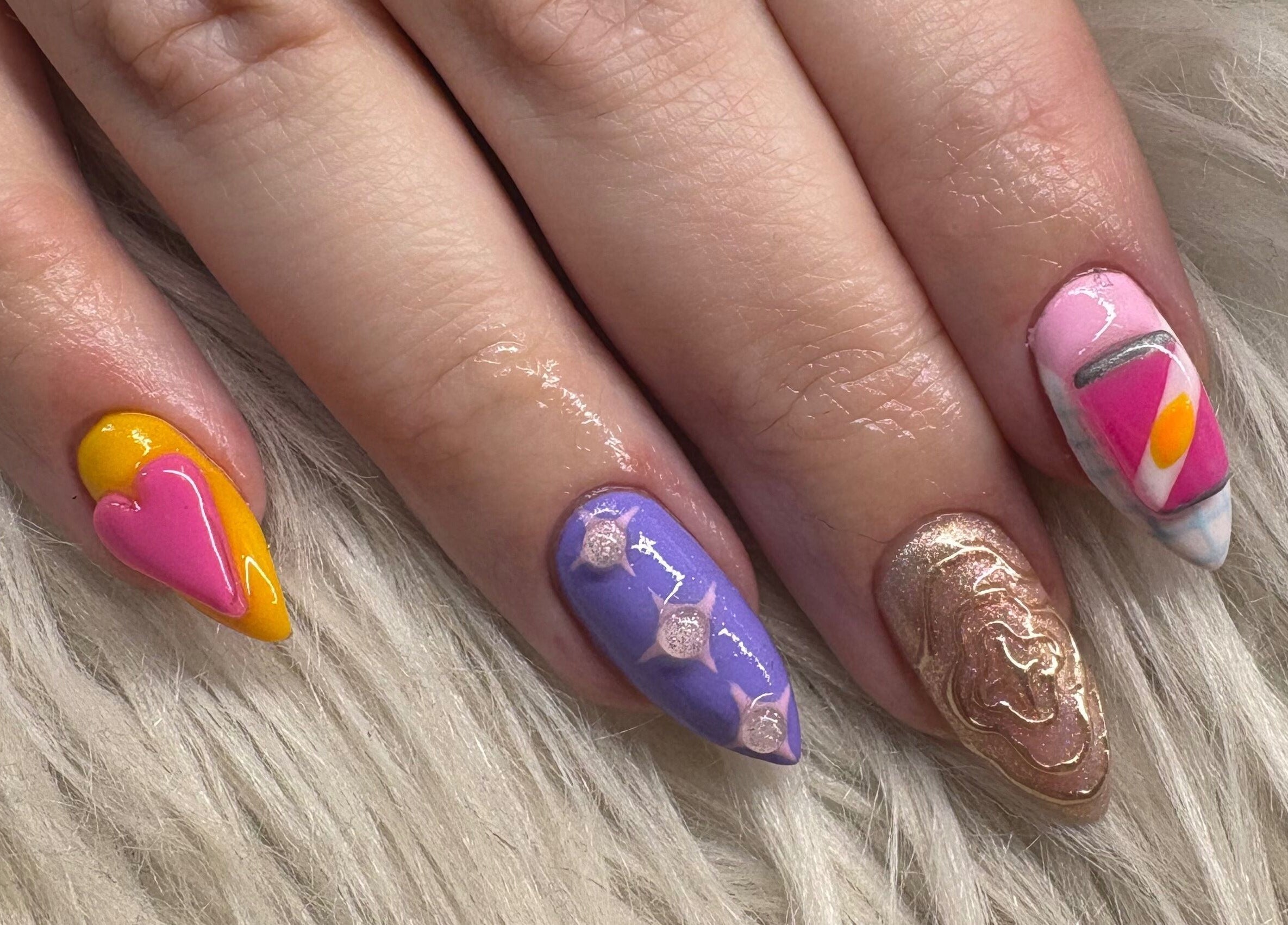 Colorful nail art at Haus of Pixiee, Pontyclun, Wales, GB with pink heart and abstract designs.