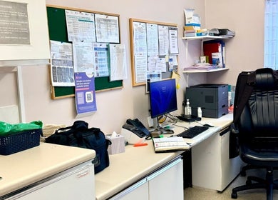 Office corner at Shannaz Aesthetics, Luton, England, GB with desk, chair, and bulletin board.