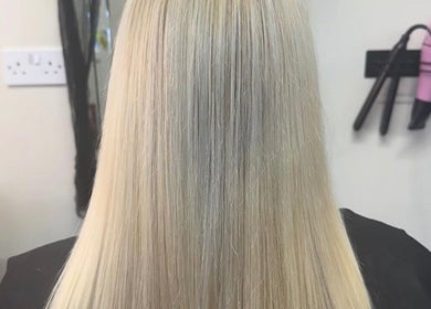 Sleek blonde hair styled at Flawless Moments, North Shields, England, GB with professional hair tools.