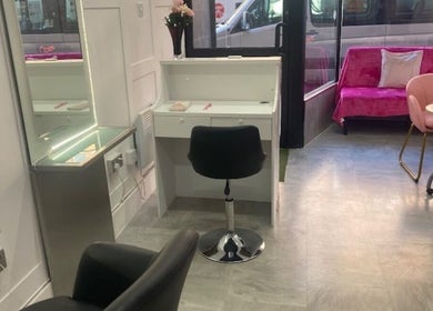 Cozy salon interior at Hair By Sarah, Glasgow, Scotland, GB with chic styling chair and vibrant decor.