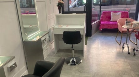 Cozy salon interior at Hair By Sarah, Glasgow, Scotland, GB with chic styling chair and vibrant decor.