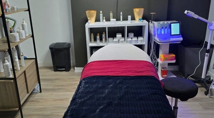 Treatment room at Beauty & Body Sugaring Sarnia, Sarnia, Ontario, CA, featuring cozy bed and skincare products.