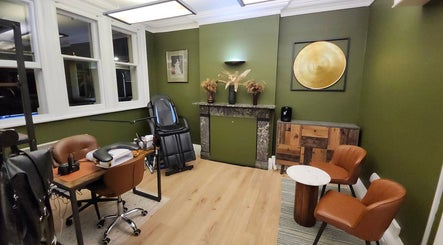 Luxurious therapy room in Tati Beauty, Manchester, England, GB with chic decor and comfortable seating.