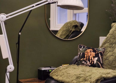 Cozy corner at Tati Beauty, Manchester, England, GB with plush green decor and elegant lighting.