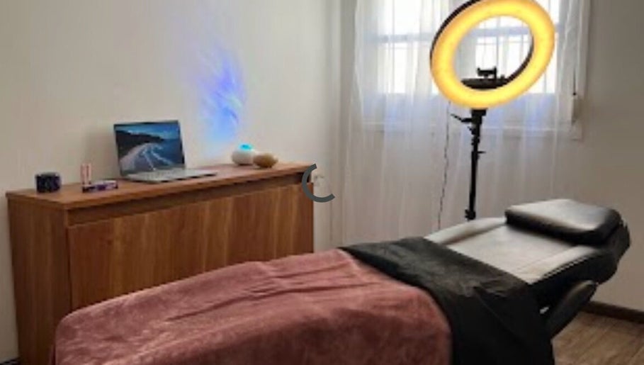 Cozy treatment room at Yoss, Montevideo, Departamento De Montevideo, UY with massage bed and ring light.