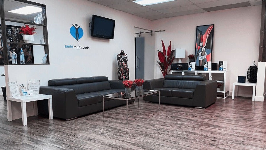 Elegant lounge at NB Ostéo/Kin in Laval, Québec, CA with modern sofas, art, and decor elements.