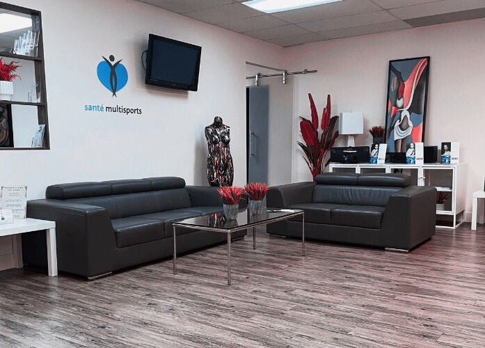 Elegant lounge at NB Ostéo/Kin in Laval, Québec, CA with modern sofas, art, and decor elements.