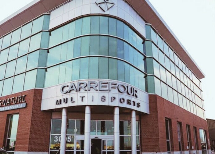 NB Ostéo/Kin building at Laval, Québec, CA with glass facade and multi-sports signage.