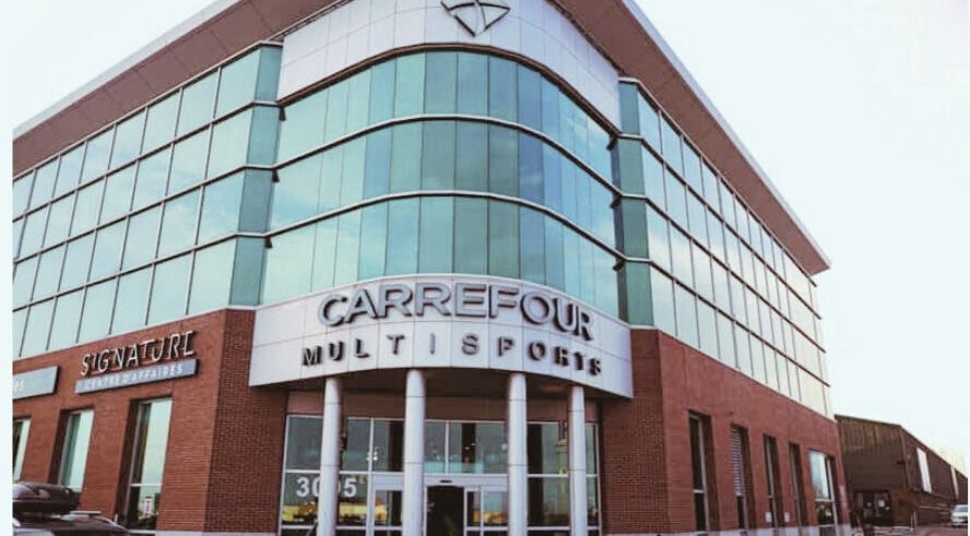 NB Ostéo/Kin building at Laval, Québec, CA with glass facade and multi-sports signage.