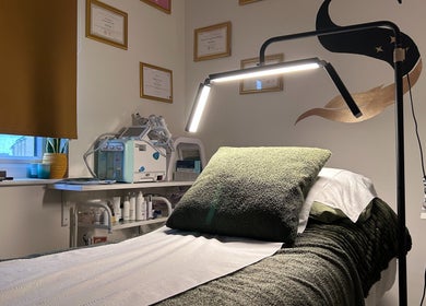 Relaxing treatment room at SWEY Aesthetics, Milton Keynes, England, GB, with a soft-lit ambiance.