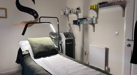 Calm treatment room at SWEY Aesthetics, Milton Keynes, England with treatment bed, products, and ambient lighting.