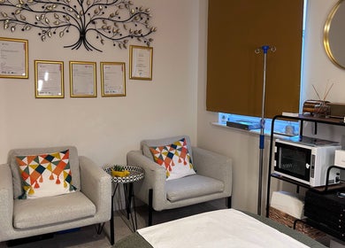 Comfortable seating area at SWEY Aesthetics, Milton Keynes, England, GB with decor and wellness equipment.