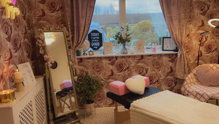 Cozy beauty treatment room at Angela's Beauty, Bradford, England, GB with rose wallpaper and elegant decor.