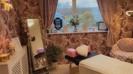 Cozy beauty treatment room at Angela's Beauty, Bradford, England, GB with rose wallpaper and elegant decor.