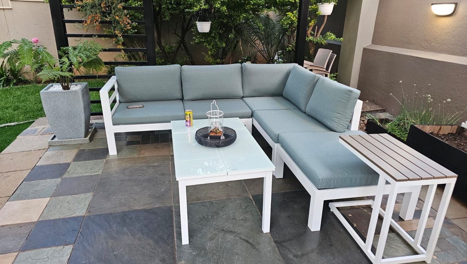 Outdoor seating area at Capetown, Cape Town, Western Cape, ZA, with cushioned sofas and green plants.