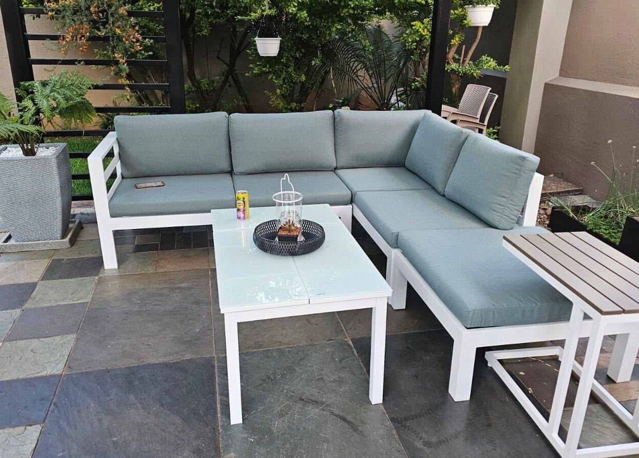 Outdoor seating area at Capetown, Cape Town, Western Cape, ZA, with cushioned sofas and green plants.