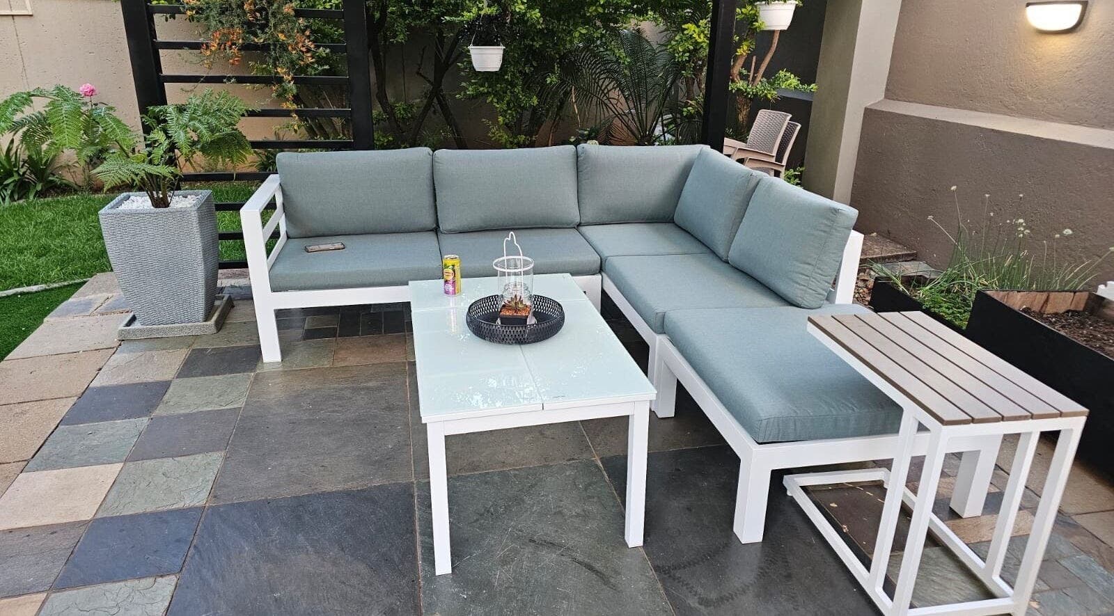 Outdoor seating area at Capetown, Cape Town, Western Cape, ZA, with cushioned sofas and green plants.