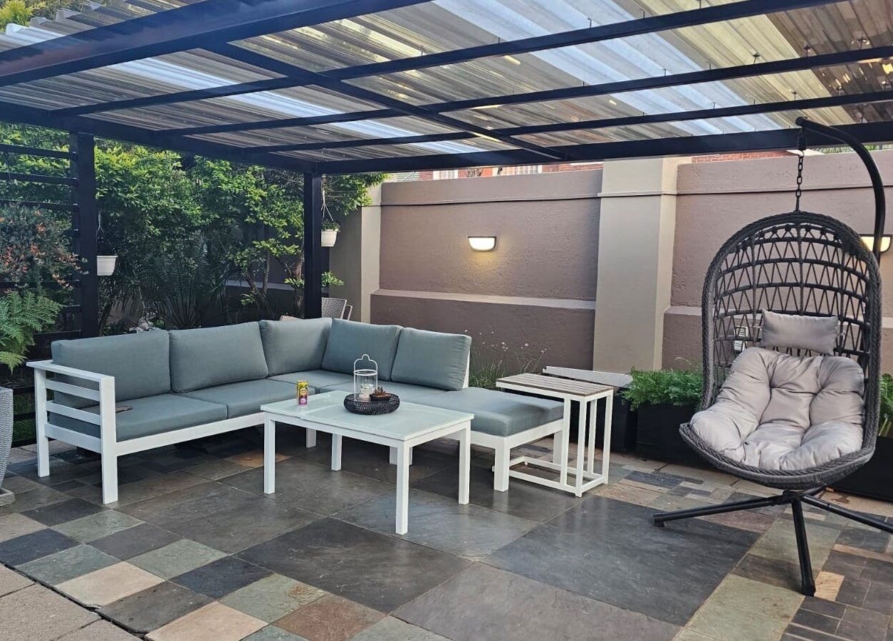 Elegant outdoor patio at Capetown in Cape Town, Western Cape, ZA featuring modern seating and lush greenery.