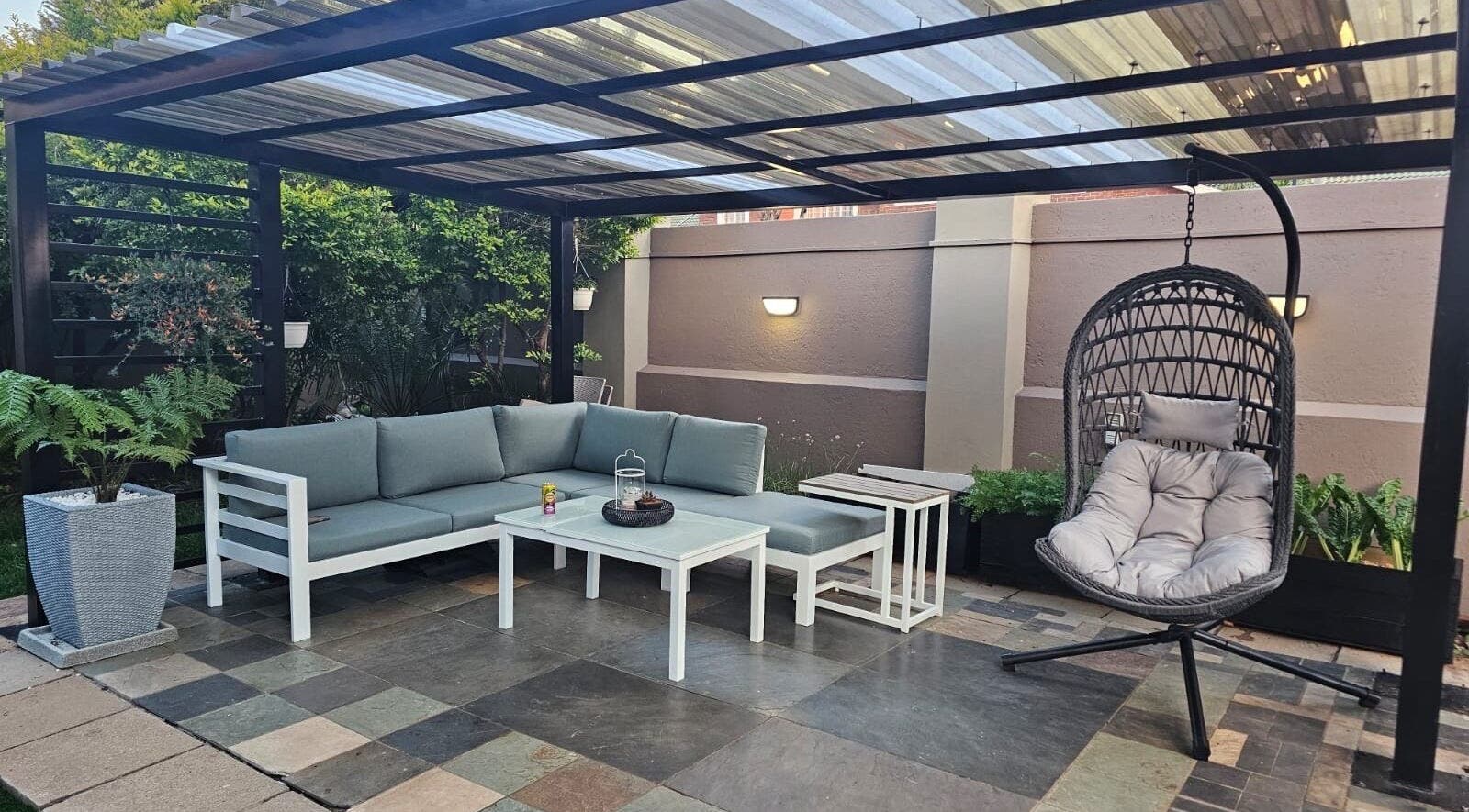 Elegant outdoor patio at Capetown in Cape Town, Western Cape, ZA featuring modern seating and lush greenery.