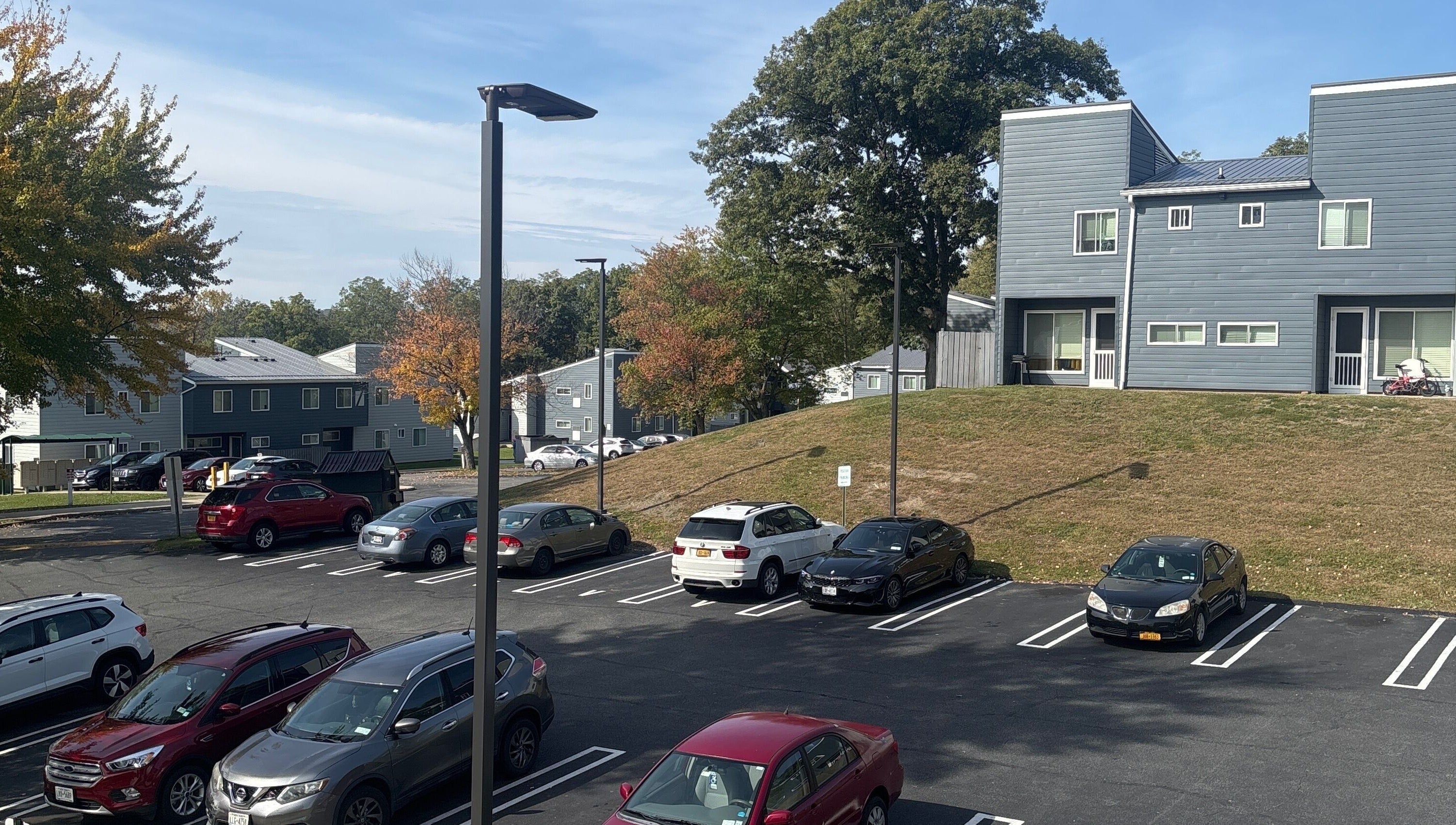 Scenic parking view at Leschae Braids 2.0, Beacon, New York, showcasing modern architecture and autumn trees.