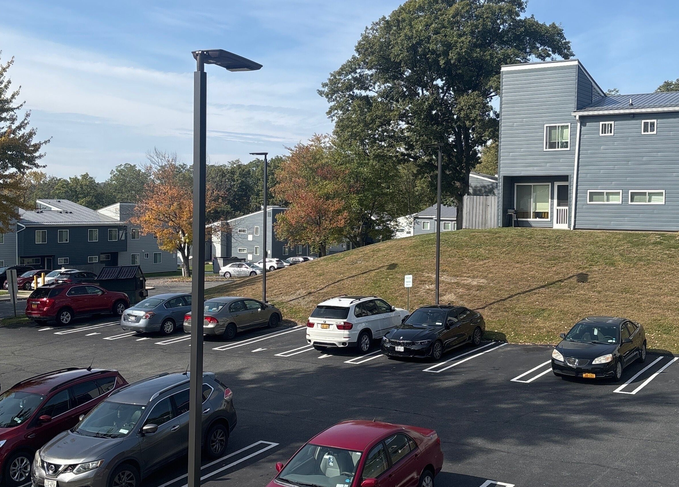 Scenic parking view at Leschae Braids 2.0, Beacon, New York, showcasing modern architecture and autumn trees.