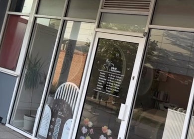 Entrance of D&M Nails Salon in Bletchley, England, GB with glass doors and stylish signage.
