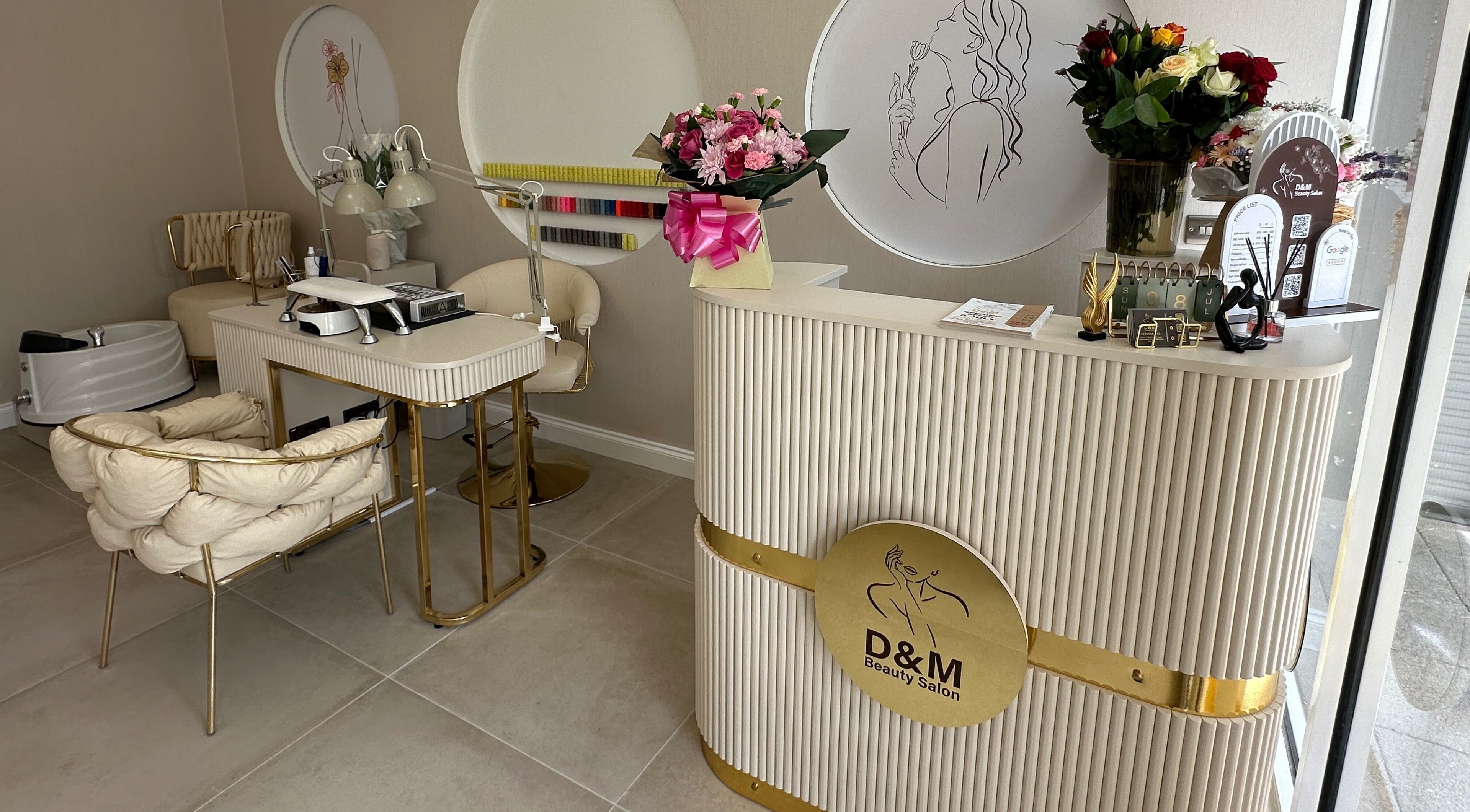 Elegant interior of D&M Nails Salon in Bletchley, England, GB showcasing chic decor and nail stations.