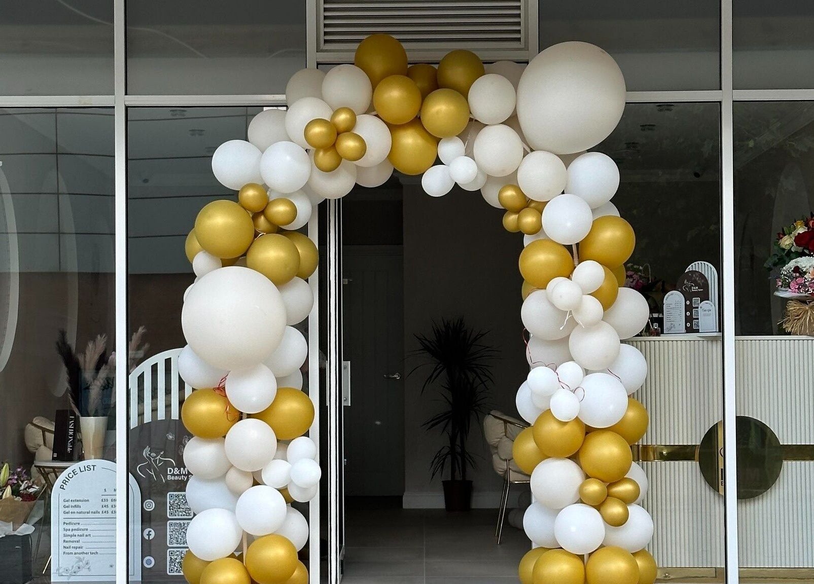 Elegant balloon arch at D&M Nails Salon entrance in Bletchley, England, GB.