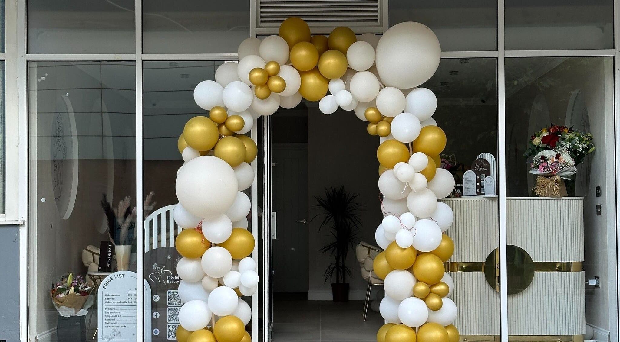 Elegant balloon arch at D&M Nails Salon entrance in Bletchley, England, GB.
