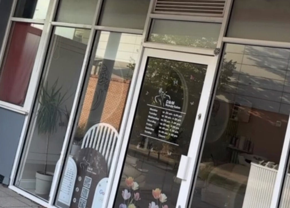 Front view of D&M Nails Salon in Bletchley, England, GB, showcasing modern glass entrance decor.