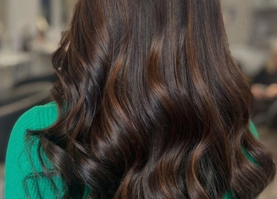 Beautiful glossy curls styled at Vikki’s Hair, Appledore, England, GB. Perfect for a stylish and elegant look.