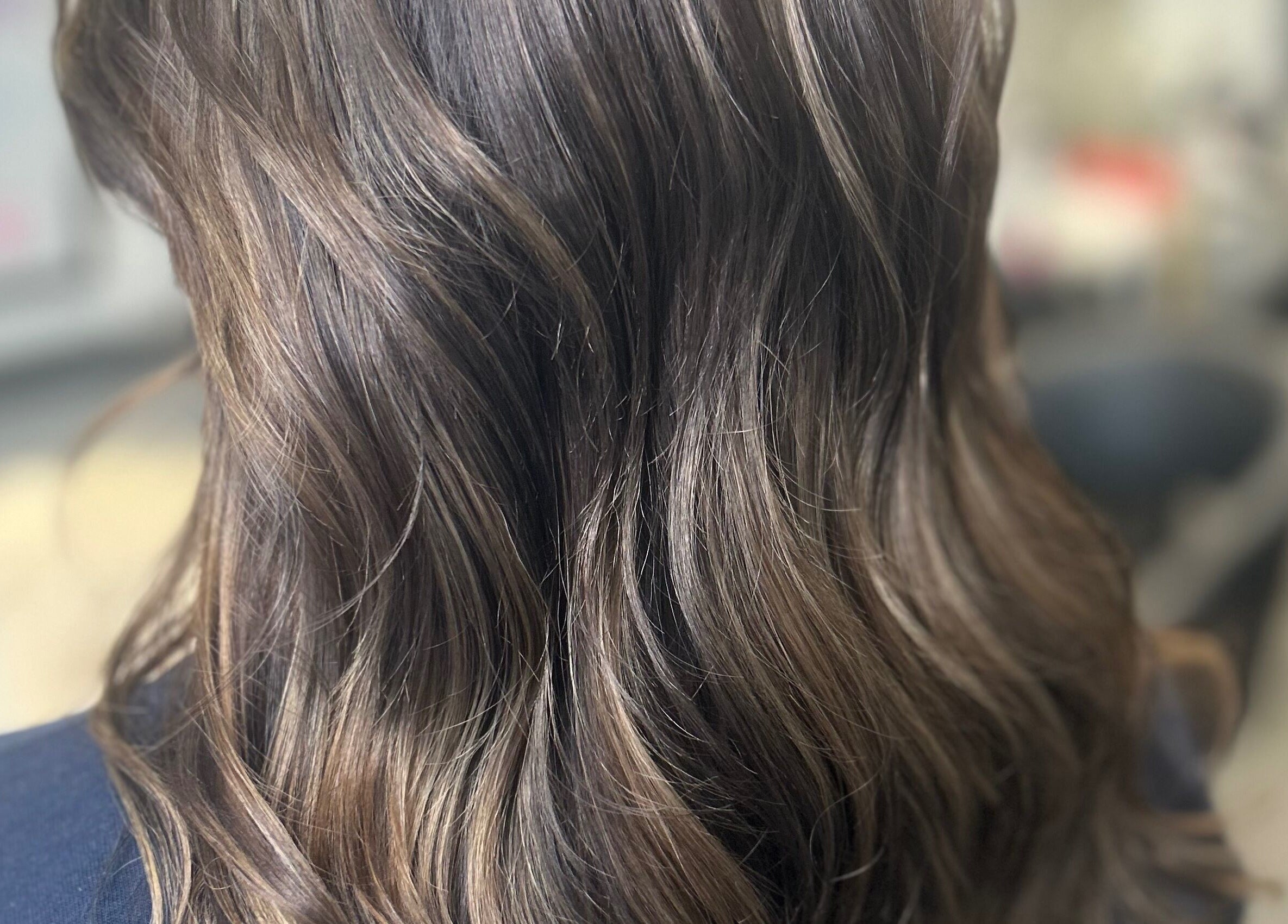 Shiny brown hair waves styled at Vikki’s Hair, Appledore, England, GB.