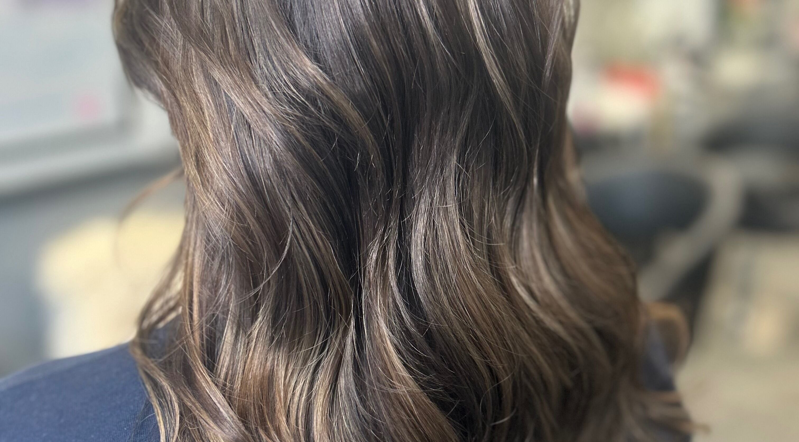 Shiny brown hair waves styled at Vikki’s Hair, Appledore, England, GB.