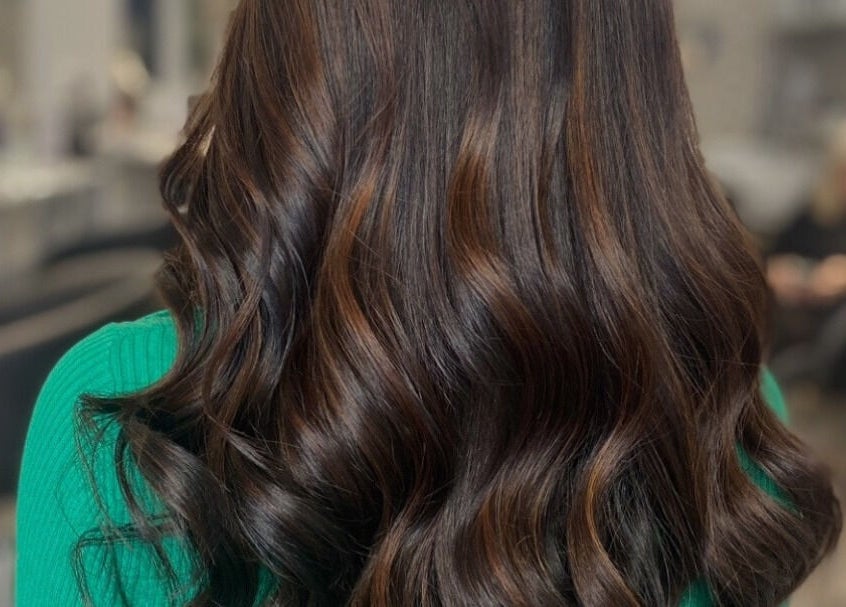 Brunette hair with elegant waves styled at Vikki’s Hair, Appledore, England, GB.