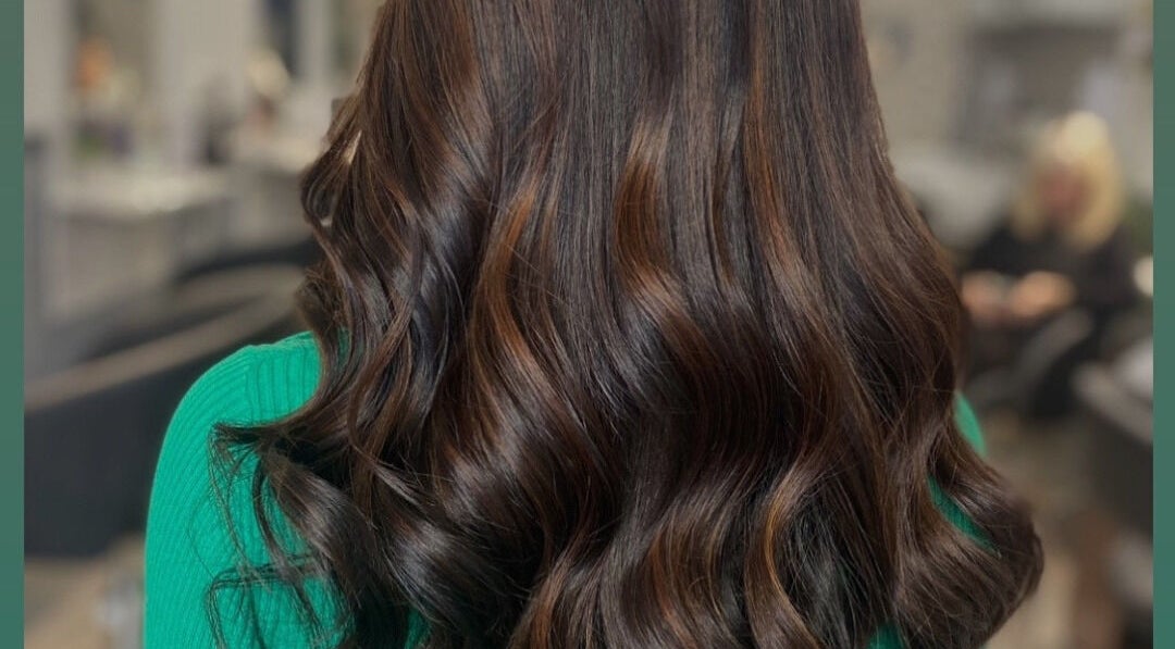 Brunette hair with elegant waves styled at Vikki’s Hair, Appledore, England, GB.