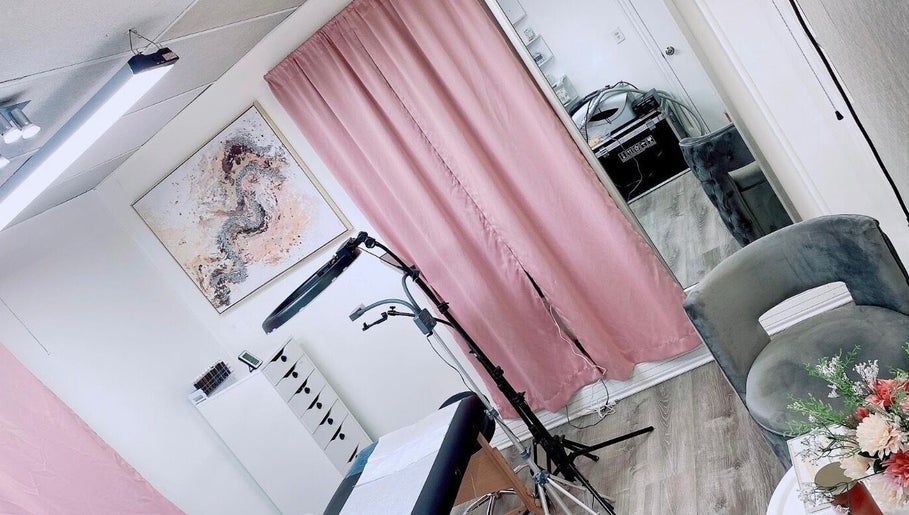 Inviting tattoo studio with pink curtains at Perfect Illusion Tattoo, Reading, Pennsylvania, US.