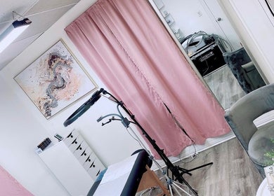 Inviting tattoo studio with pink curtains at Perfect Illusion Tattoo, Reading, Pennsylvania, US.