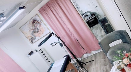 Inviting tattoo studio with pink curtains at Perfect Illusion Tattoo, Reading, Pennsylvania, US.