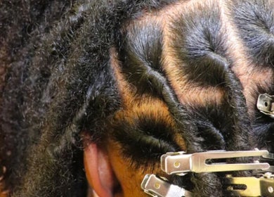 Natural locs styled at Retwist Locs, Nassau, New Providence, BS, showcasing textured hair beauty.