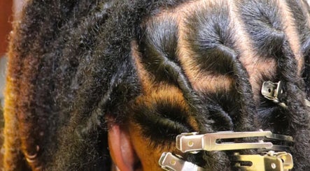 Natural locs styled at Retwist Locs, Nassau, New Providence, BS, showcasing textured hair beauty.