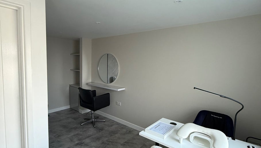 Modern beauty station at Honey Luxe Nails, Gosport, England, GB, featuring a sleek chair and round mirror.